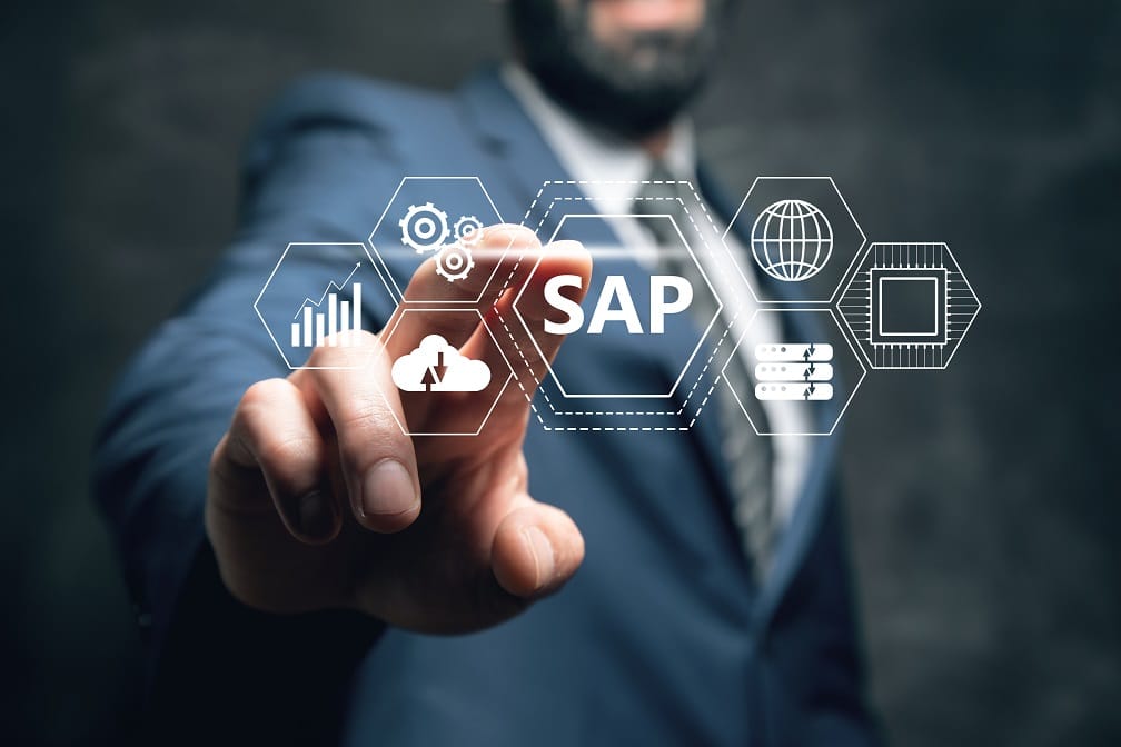 Businessman in a suit interacting with virtual interface displaying SAP icons, representing cloud computing, data analytics, and enterprise software integration.